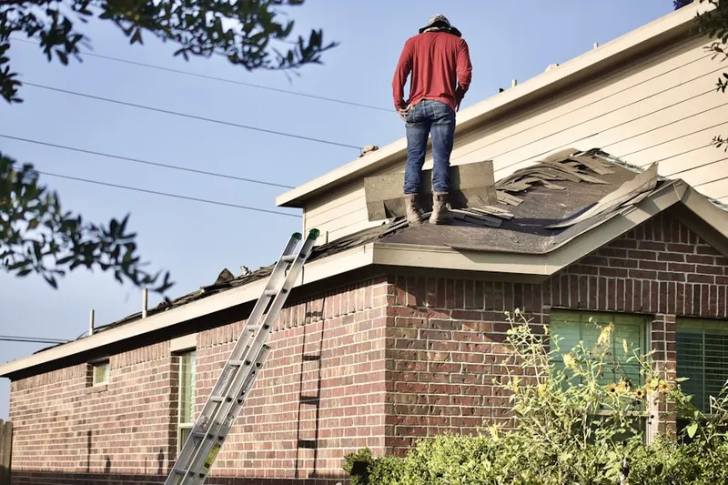 Professional roofer working on a residential roof in Chattahoochee Hills